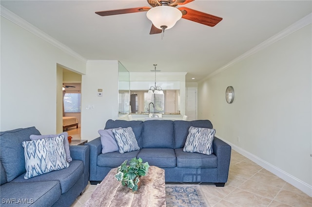 living room with ceiling fan with notable chandelier, crown molding, and light tile patterned floors