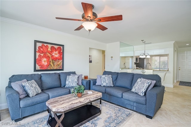 living room featuring light tile patterned flooring, ceiling fan with notable chandelier, crown molding, and sink