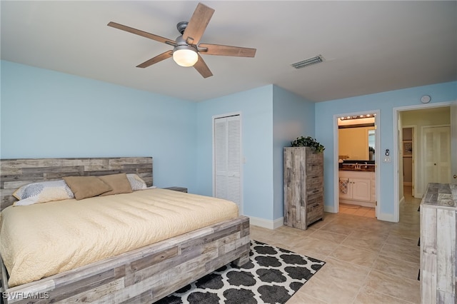 bedroom featuring ceiling fan, a closet, ensuite bath, and light tile patterned floors