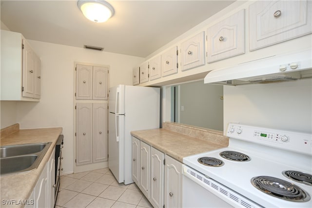 kitchen with white cabinets, sink, light tile patterned floors, and white appliances