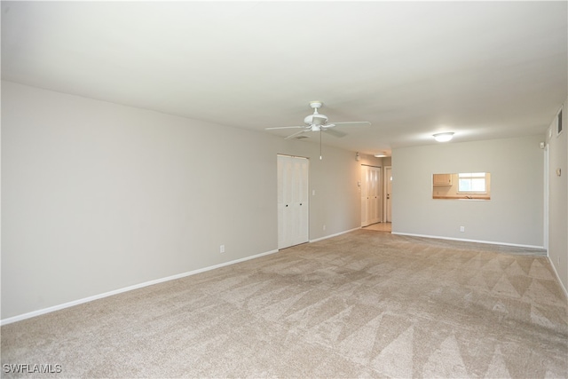 empty room featuring light carpet and ceiling fan