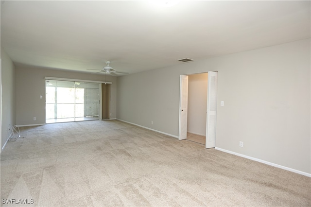 carpeted empty room featuring ceiling fan