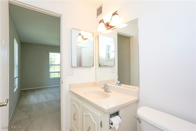 bathroom featuring vanity and toilet