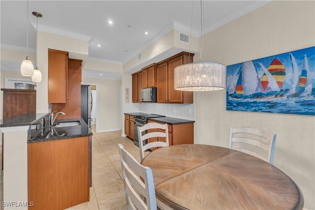 tiled dining area featuring ornamental molding and sink