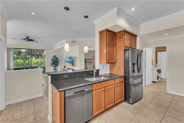 kitchen featuring appliances with stainless steel finishes, hanging light fixtures, ceiling fan, dark stone counters, and ornamental molding