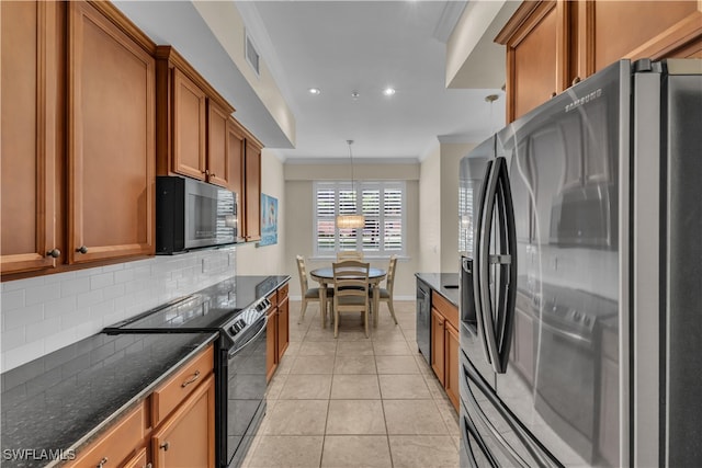 kitchen featuring range with electric stovetop, backsplash, light tile patterned floors, decorative light fixtures, and stainless steel fridge with ice dispenser