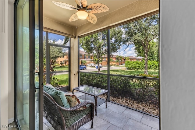 sunroom featuring ceiling fan