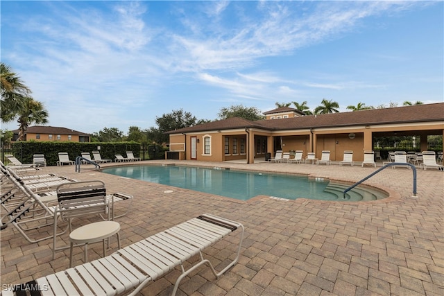 view of swimming pool with a patio