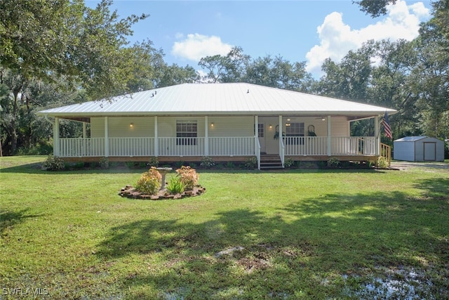 back of property featuring a yard and a storage shed