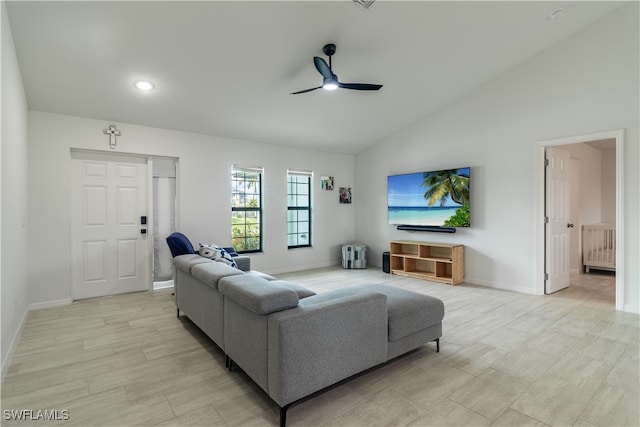 living room featuring ceiling fan and lofted ceiling