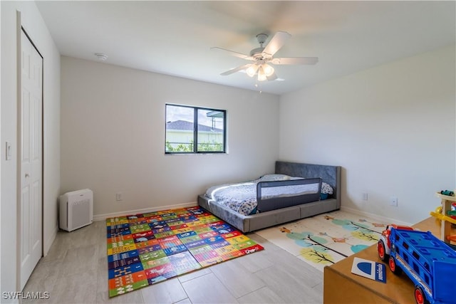 bedroom with ceiling fan and a closet