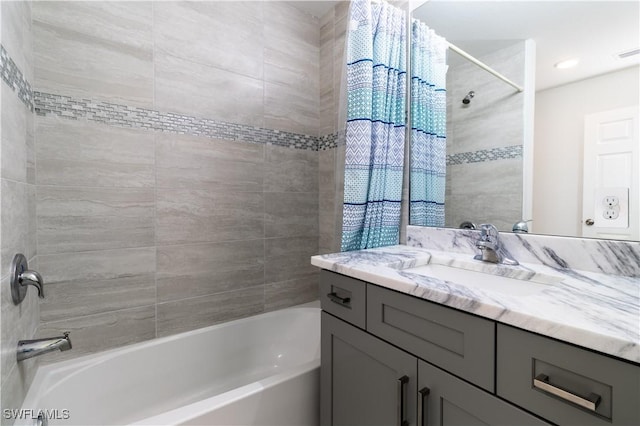 bathroom featuring vanity and tiled shower / bath combo