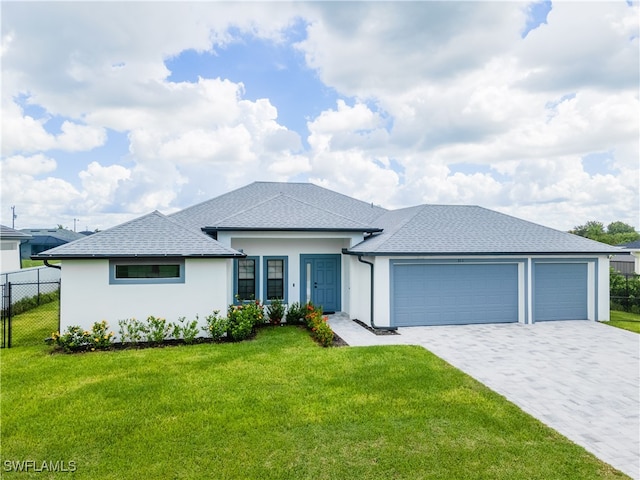 view of front of house with a garage and a front lawn