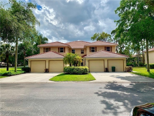 517 Robin Hood Cir Unit 102, Naples, FL 34104 - mediterranean / spanish-style house featuring driveway, stucco siding, a garage, and a tile roof