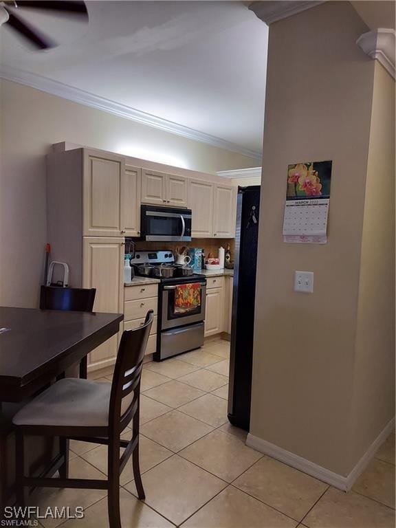 517 Robin Hood Cir Unit 102, Naples, FL 34104 - kitchen featuring stainless steel appliances, ornamental molding, light tile patterned flooring, light countertops, and baseboards