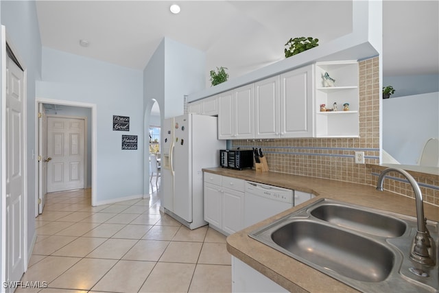 kitchen featuring sink, lofted ceiling, white cabinetry, decorative backsplash, and white appliances