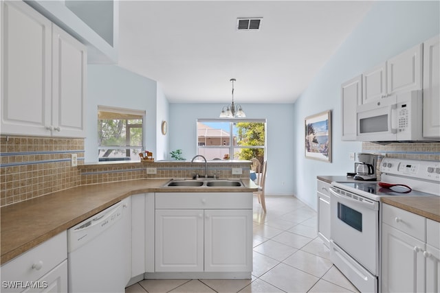 kitchen featuring white cabinets, hanging light fixtures, sink, white appliances, and decorative backsplash