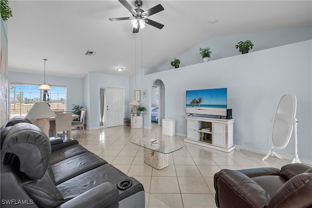 living room with vaulted ceiling, ceiling fan, and light tile patterned floors