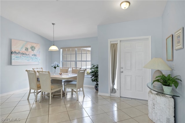 dining room featuring light tile patterned flooring and lofted ceiling