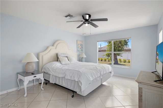 tiled bedroom featuring ceiling fan