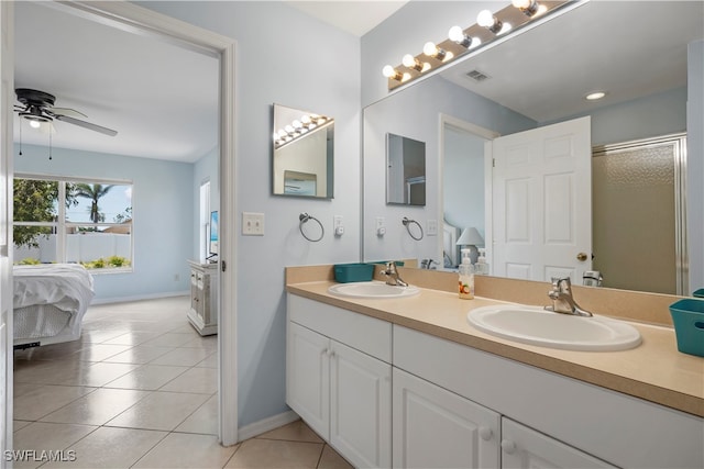 bathroom featuring ceiling fan, vanity, a shower with shower door, and tile patterned flooring