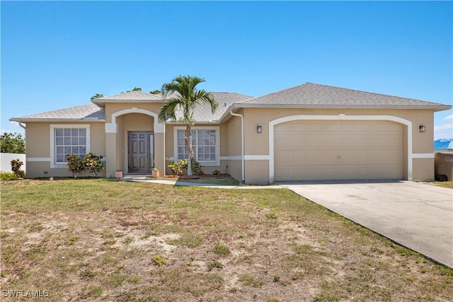 view of front of property with a front lawn and a garage