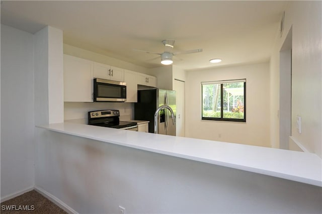 5754 Deauville Cir Unit E104, Naples, FL 34112 - kitchen with appliances with stainless steel finishes, a peninsula, light countertops, a ceiling fan, and white cabinets