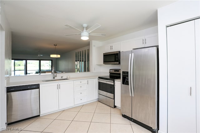 kitchen featuring sink, white cabinetry, hanging light fixtures, appliances with stainless steel finishes, and ceiling fan