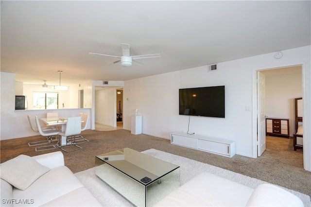 living room with ceiling fan and carpet flooring