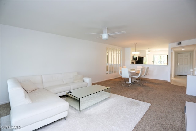 living room with carpet and ceiling fan