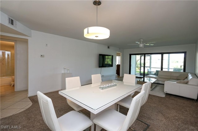 5754 Deauville Cir Unit E104, Naples, FL 34112 - dining space with light colored carpet, ceiling fan, baseboards, and light tile patterned flooring