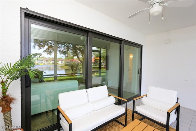 interior space featuring a water view and ceiling fan