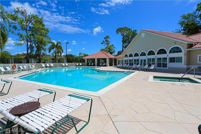 5754 Deauville Cir Unit E104, Naples, FL 34112 - community pool featuring a patio area, a hot tub, and fence