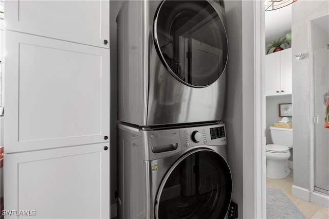 clothes washing area with stacked washer / drying machine