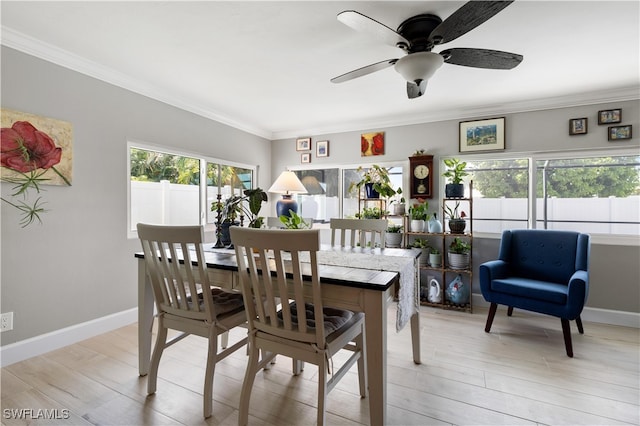 dining area featuring light wood-type flooring and crown molding