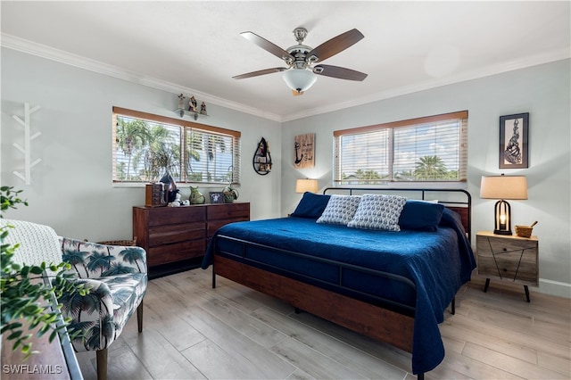 bedroom with ceiling fan, multiple windows, and light wood-type flooring