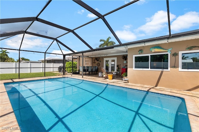 view of swimming pool with a lanai, french doors, ceiling fan, and a patio