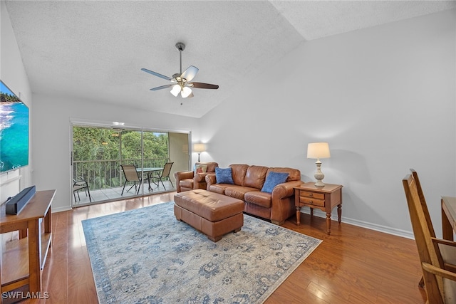 living room featuring a textured ceiling, lofted ceiling, ceiling fan, and hardwood / wood-style flooring