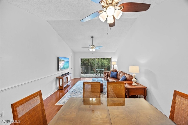 dining space featuring lofted ceiling, ceiling fan, and a textured ceiling