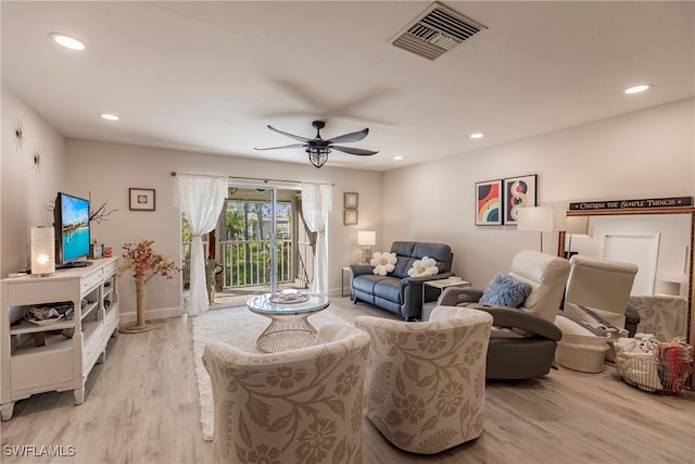 living room featuring light wood-type flooring and ceiling fan