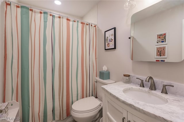 bathroom featuring walk in shower, vanity, and toilet