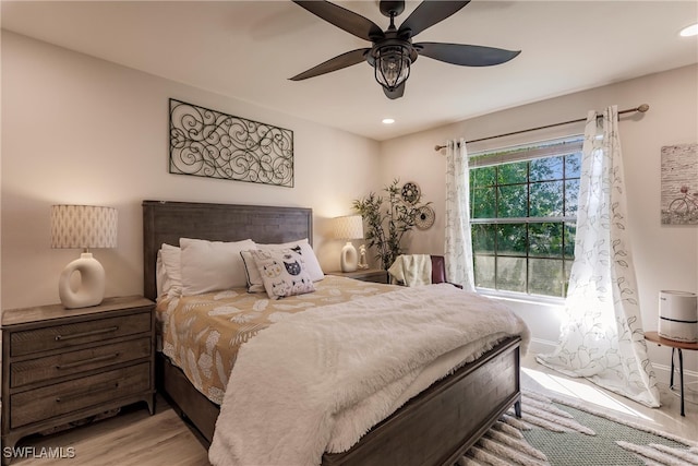 bedroom with light hardwood / wood-style flooring and ceiling fan