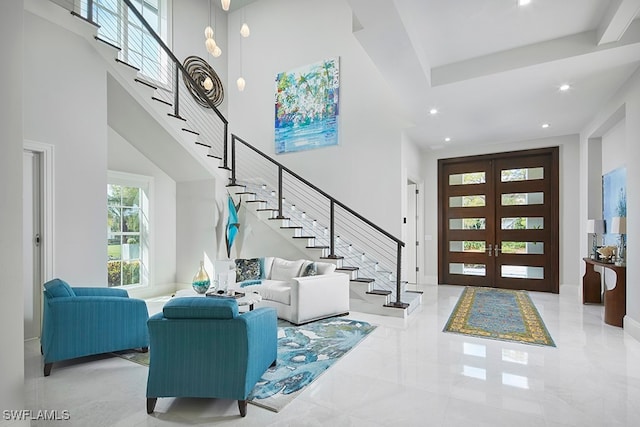 foyer featuring french doors and a high ceiling