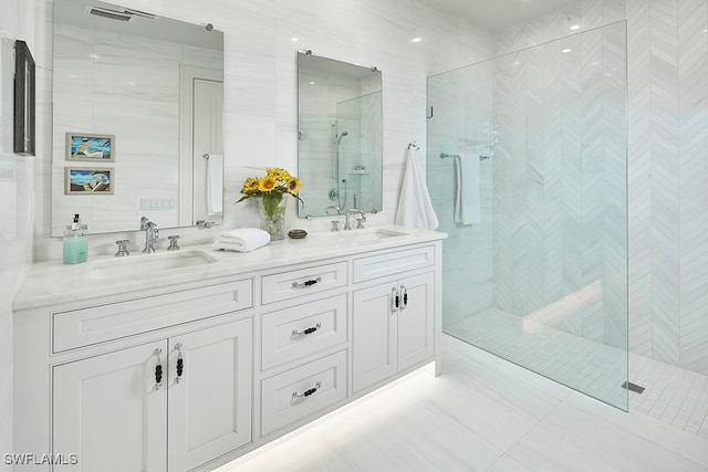 bathroom featuring tile walls, vanity, tile patterned floors, and a shower with shower door