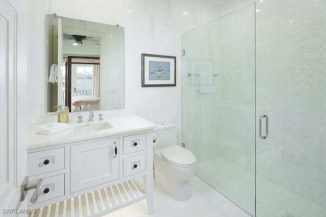 bathroom featuring tile patterned floors, vanity, toilet, ceiling fan, and a shower with shower door