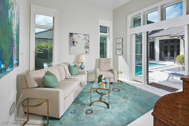 living room with plenty of natural light and carpet floors