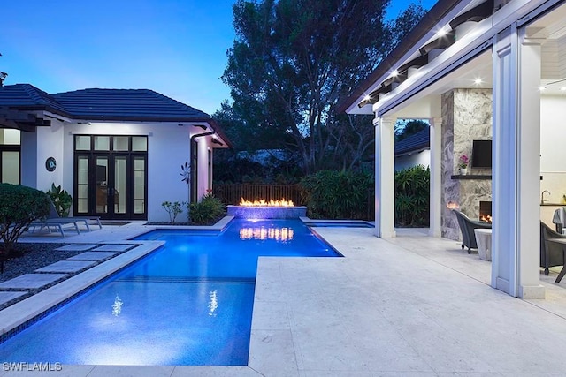 803 Shadow Lake Ln, Naples, FL 34108 - view of swimming pool featuring an outdoor stone fireplace, a patio area, french doors, and a jacuzzi