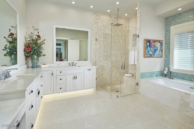 bathroom featuring vanity and separate shower and tub