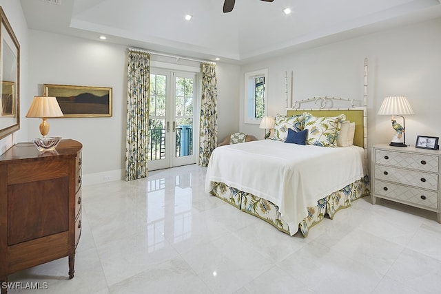 bedroom with ceiling fan, access to exterior, a raised ceiling, and french doors