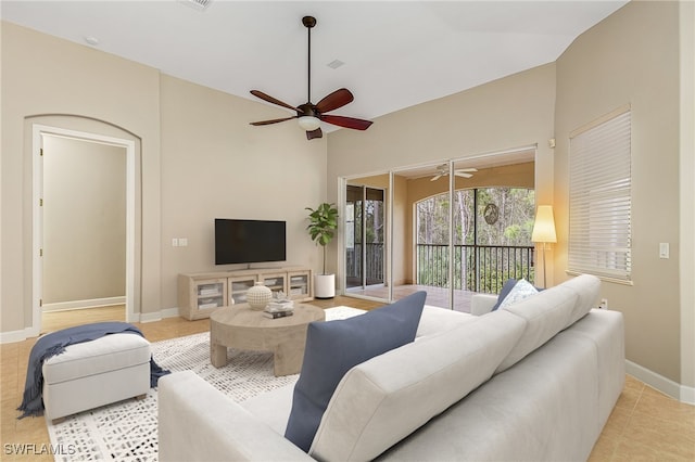 tiled living room with ceiling fan